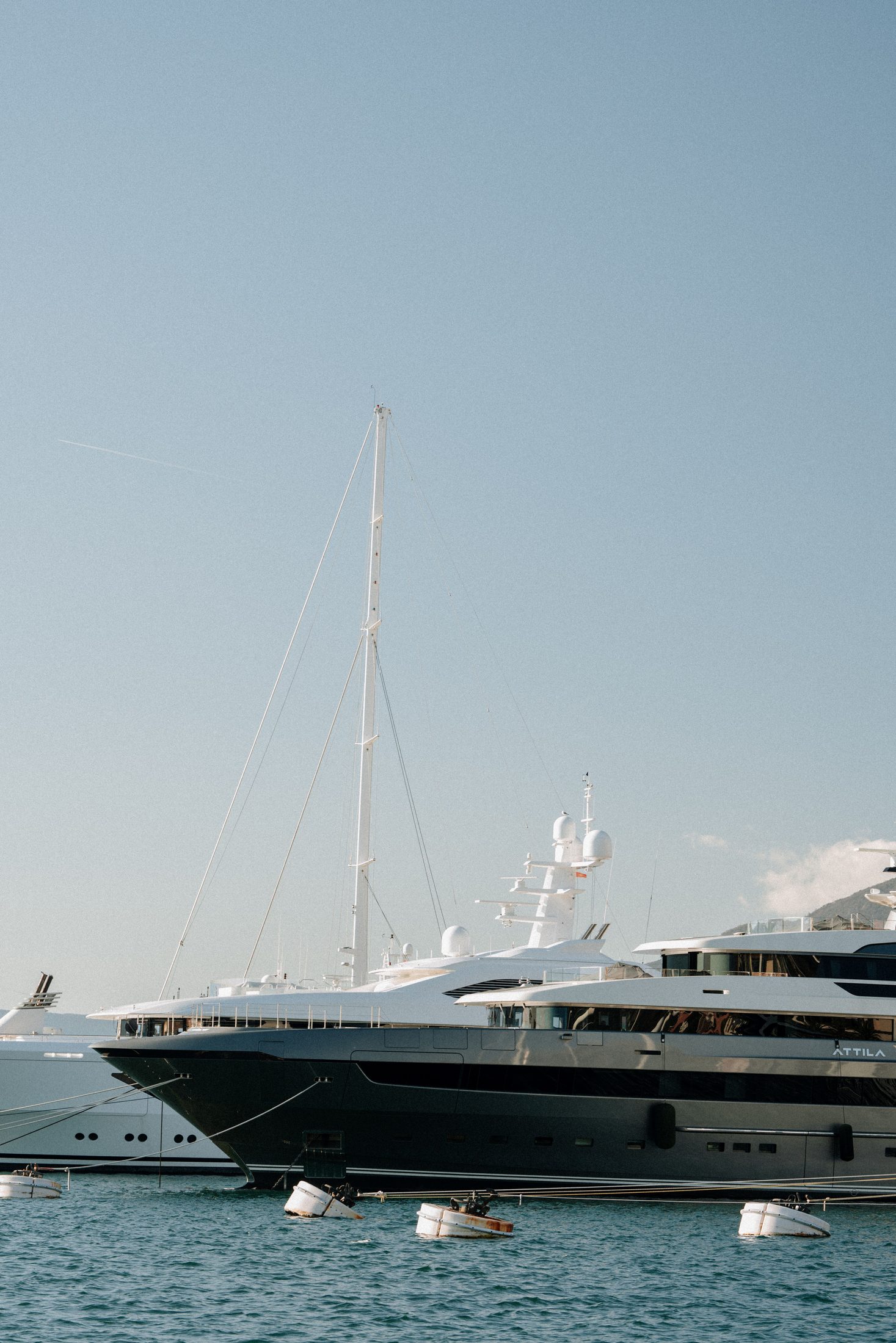 Yacht docked at a marina under a clear blue sky